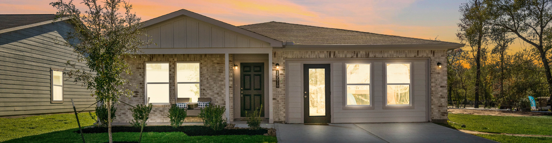 A house with a driveway and trees.
