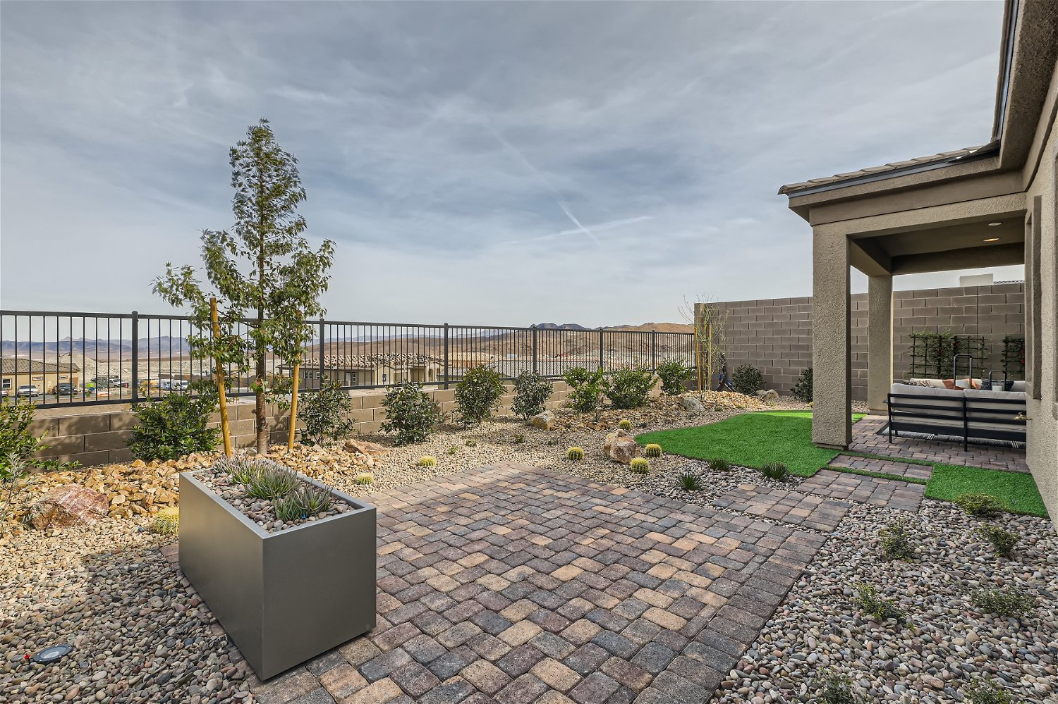 A large stone patio with a large stone structure and a large building.