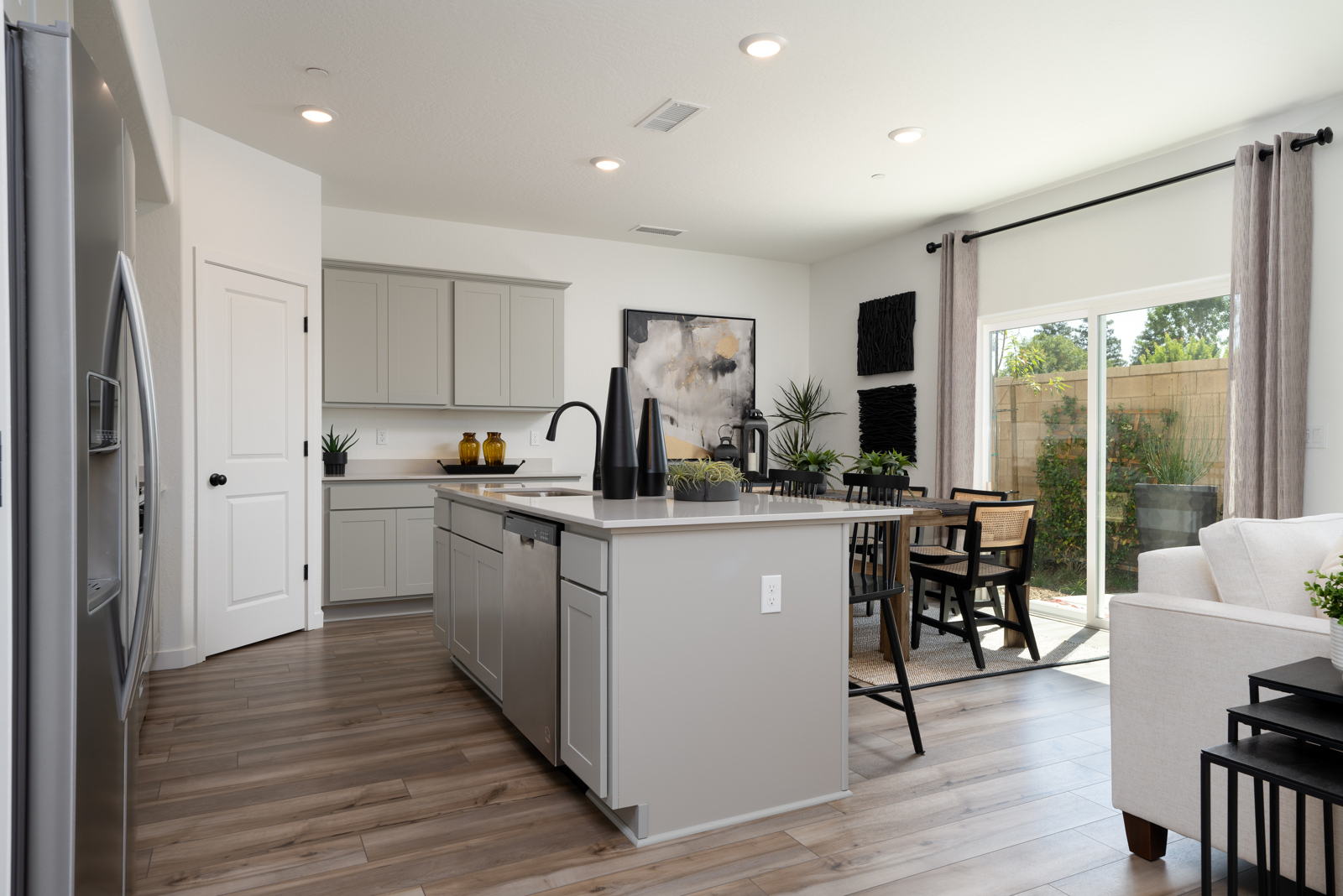 A kitchen with white cabinets.