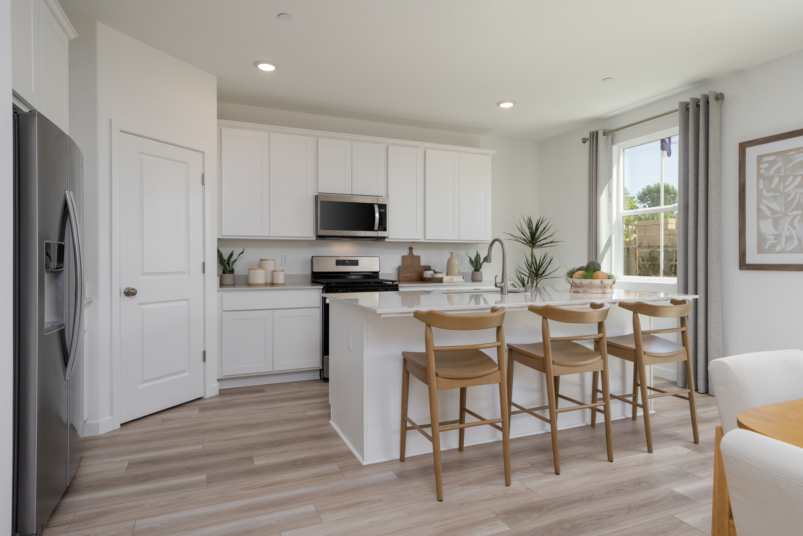 A kitchen with white cabinets.