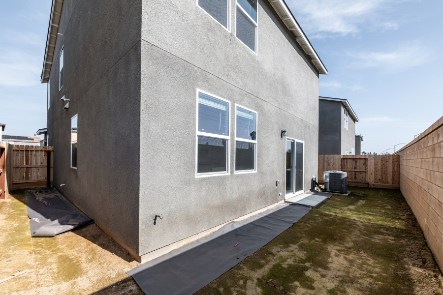 A grey building with a fence.
