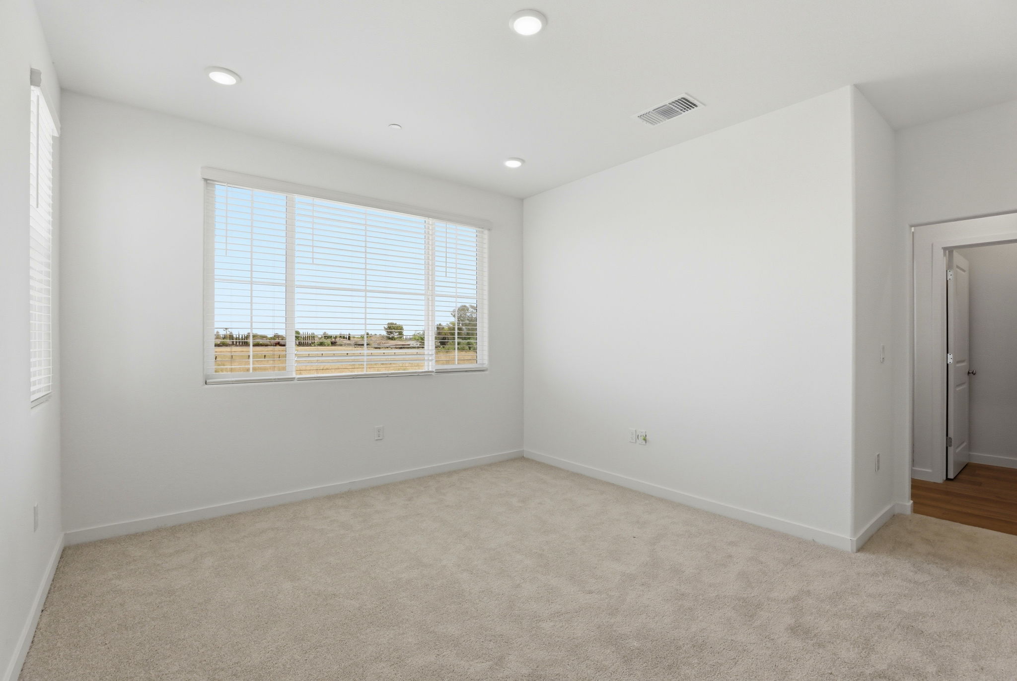 A room with a window and a door.