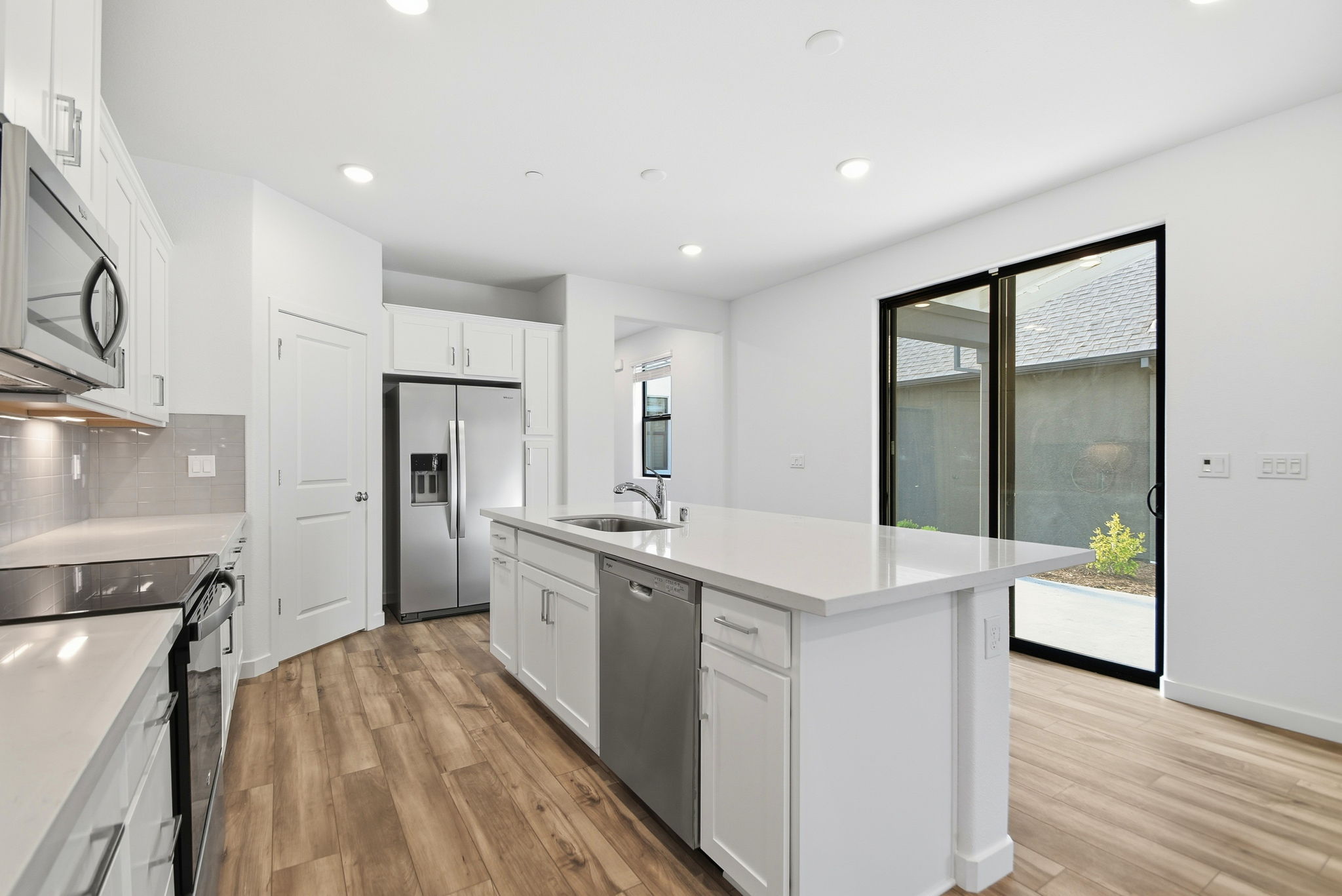 A kitchen with white cabinets.