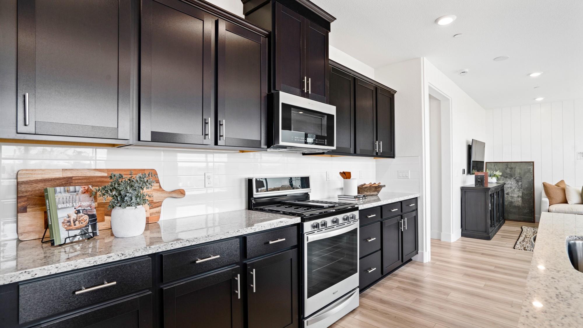 A kitchen with black cabinets.