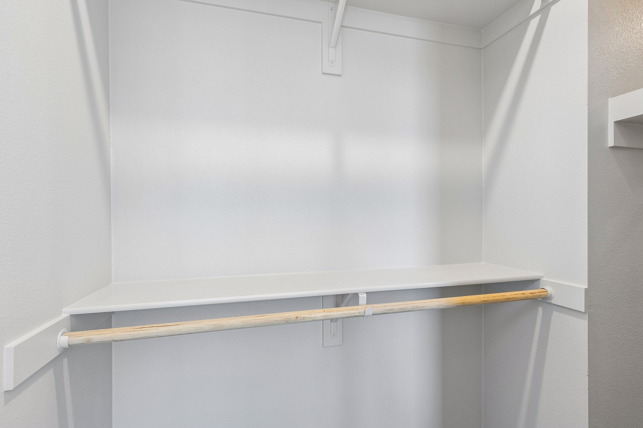 A white wall with a wooden railing.