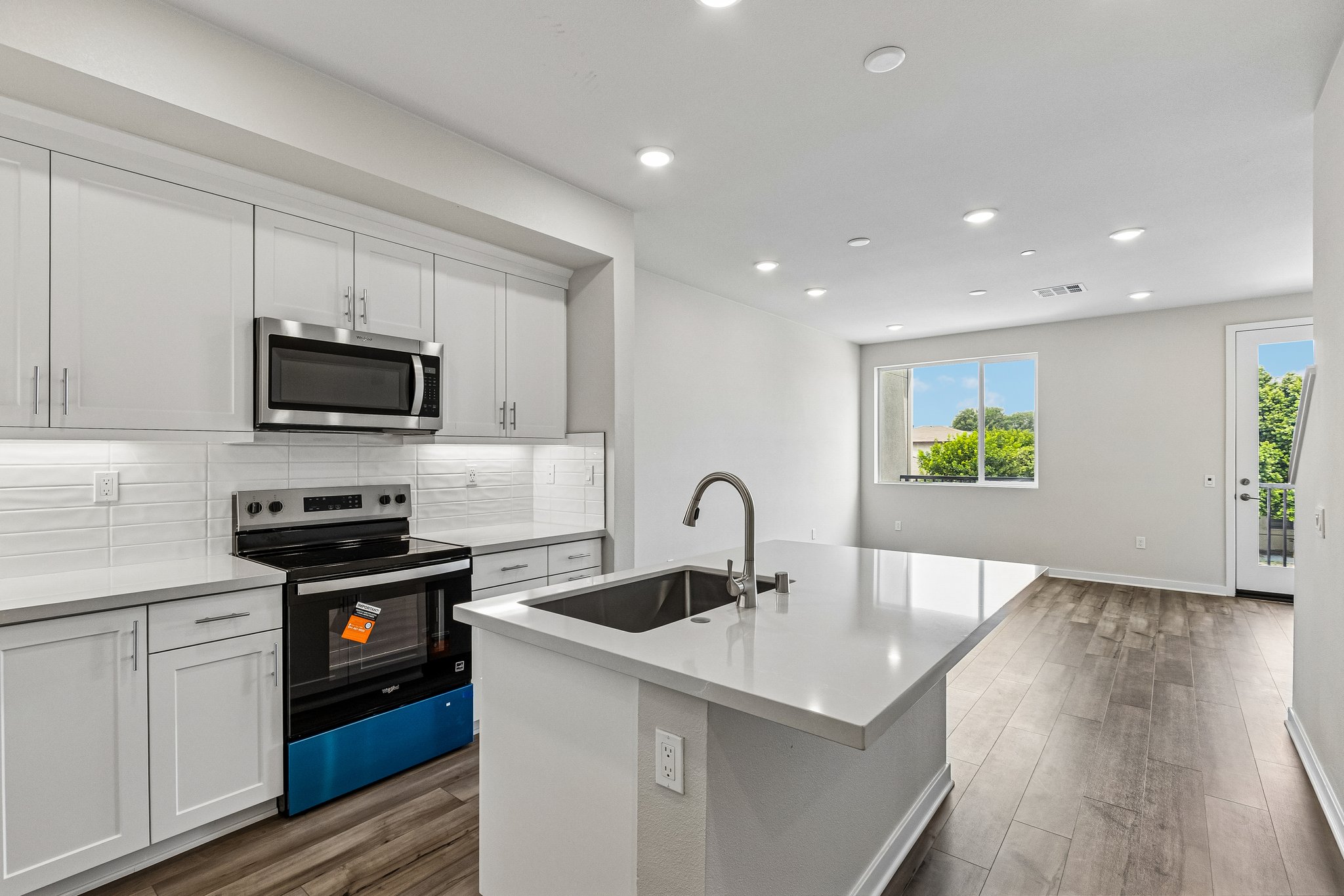 A kitchen with white cabinets.