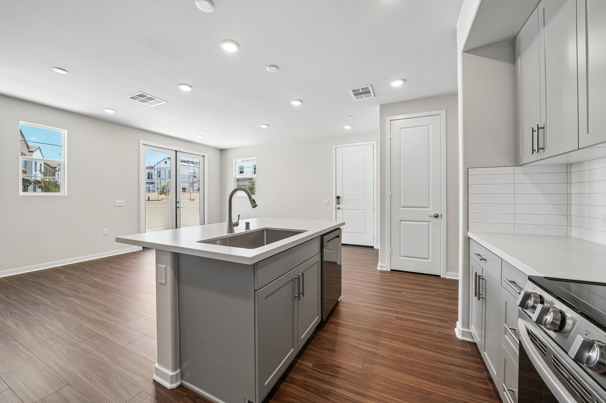 A kitchen with white cabinets.