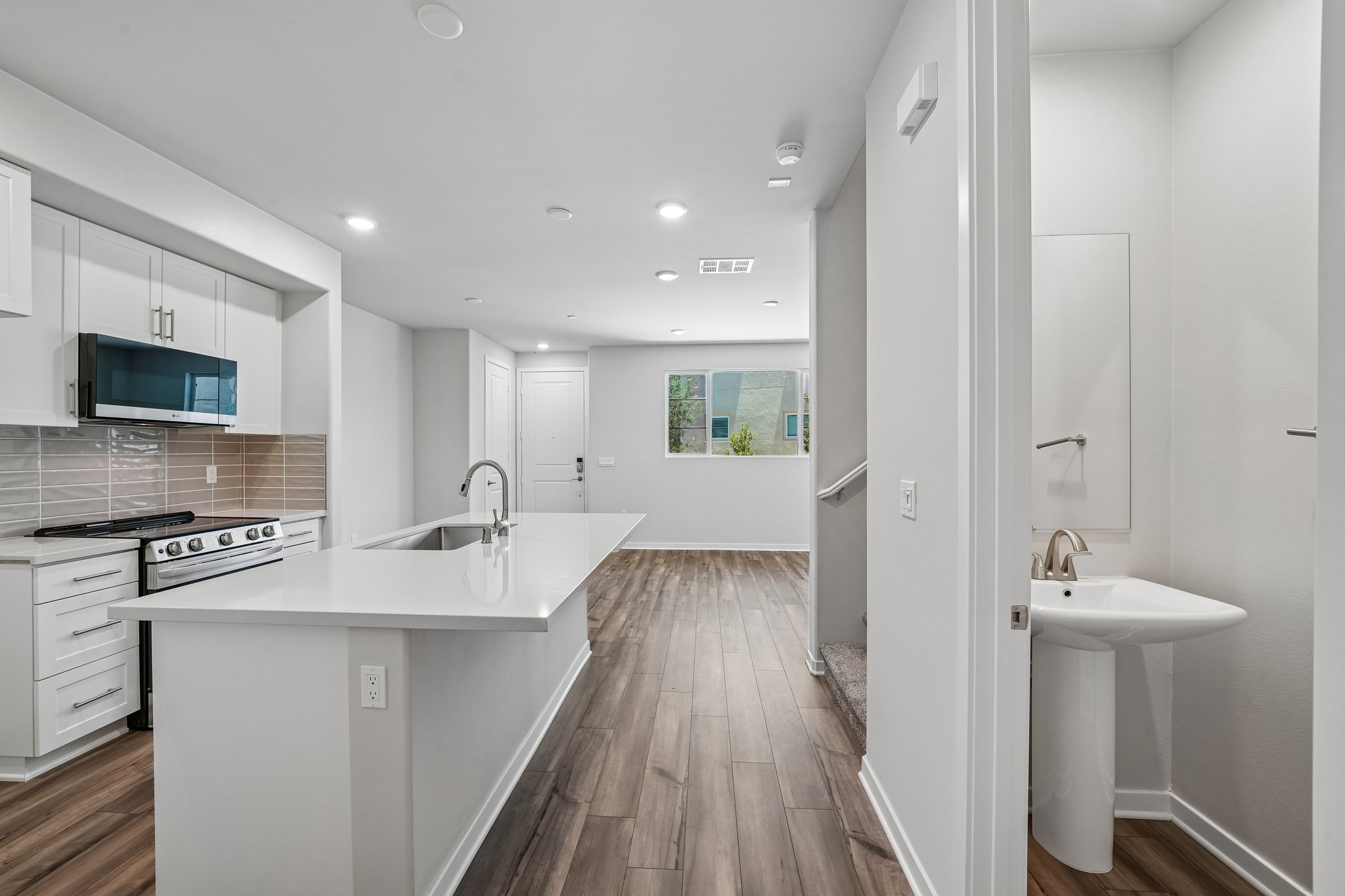 A kitchen with white cabinets.