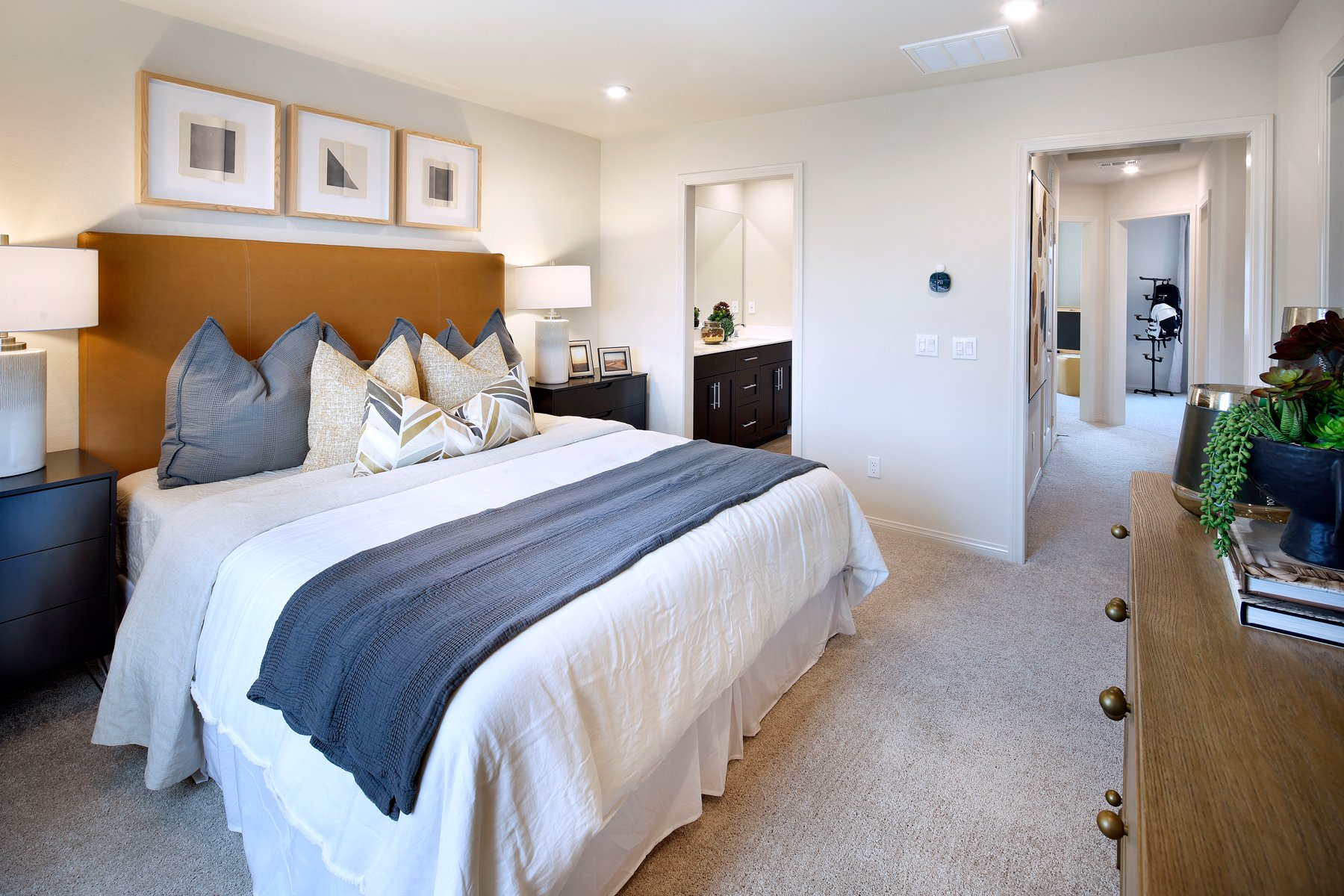 A bedroom with a bed and a mirror.