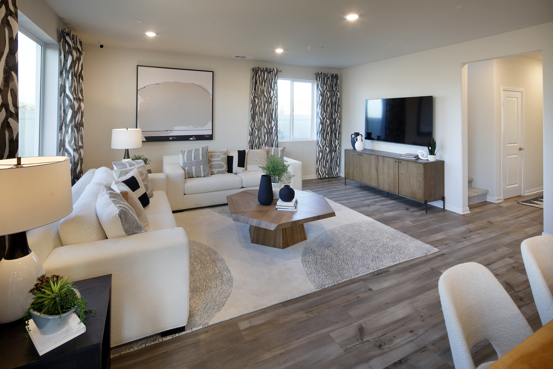 A living room with a large rug.