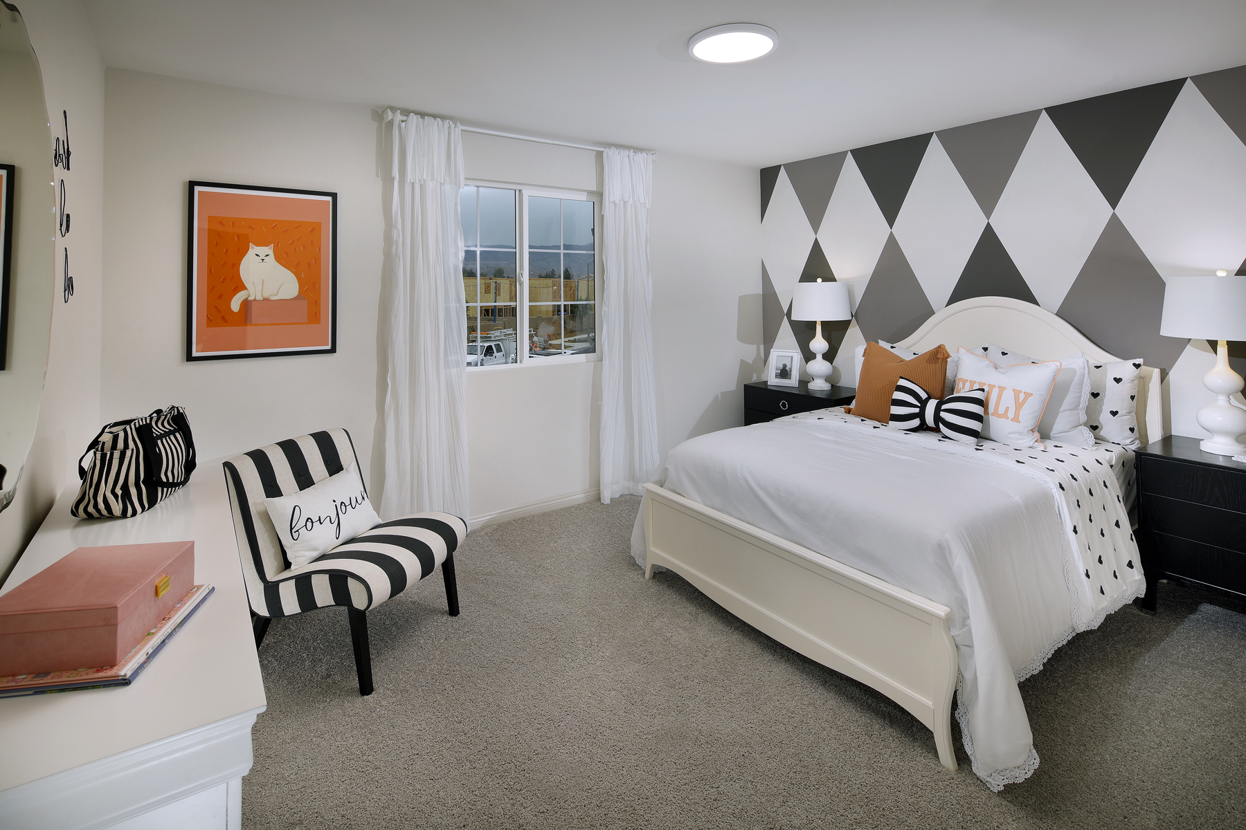 A bedroom with a bed and a chair.