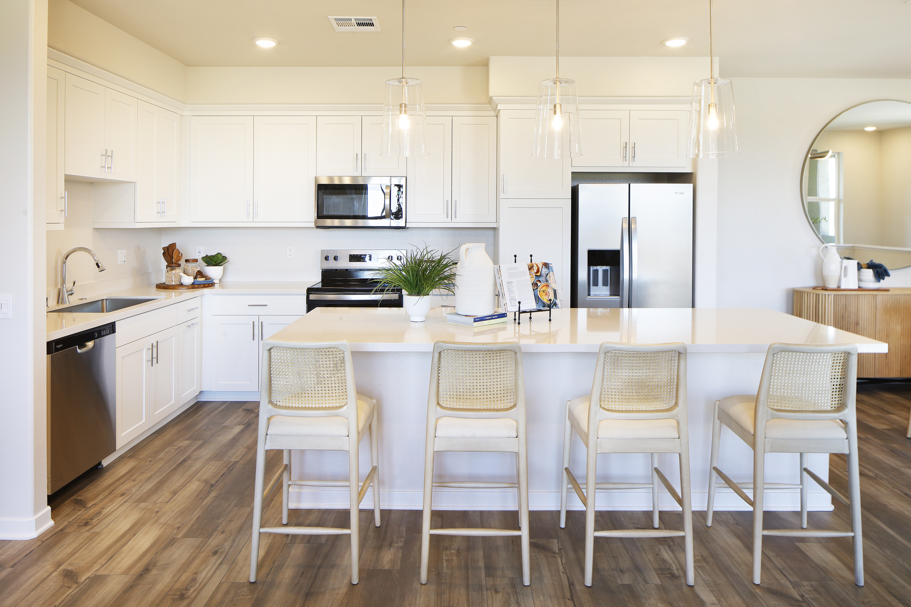 A kitchen with white cabinets.