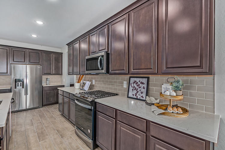 A kitchen with wooden cabinets.