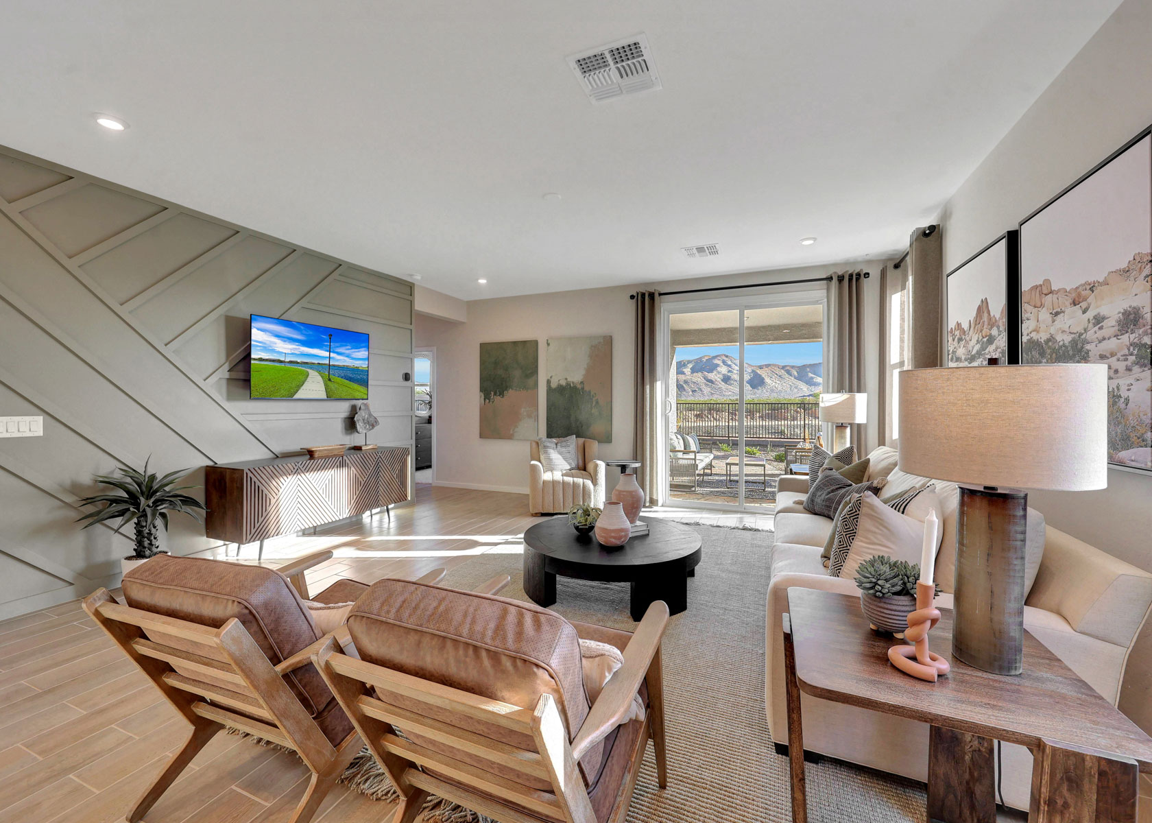 A living room with a tv and chairs.