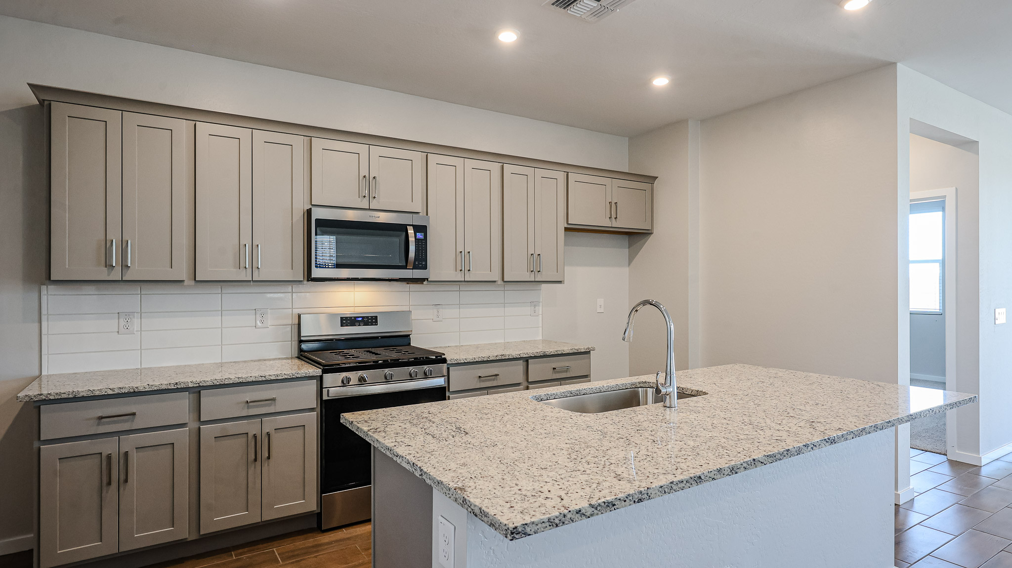 A kitchen with white cabinets.