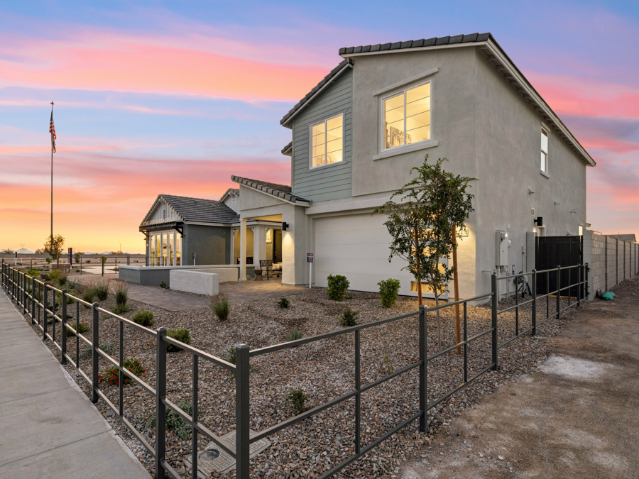 A fenced in yard with a house in the background.