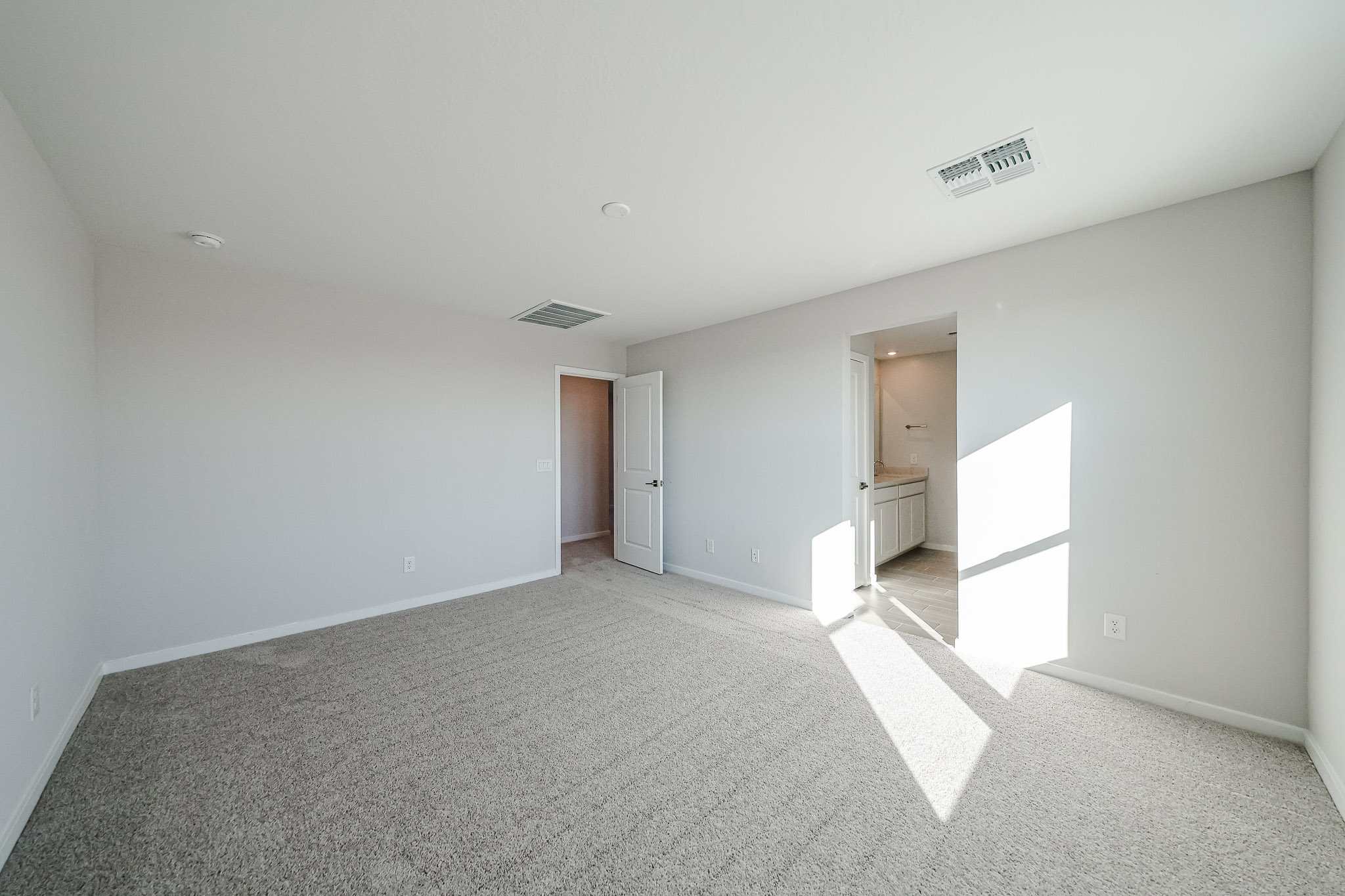 A hallway with white walls.