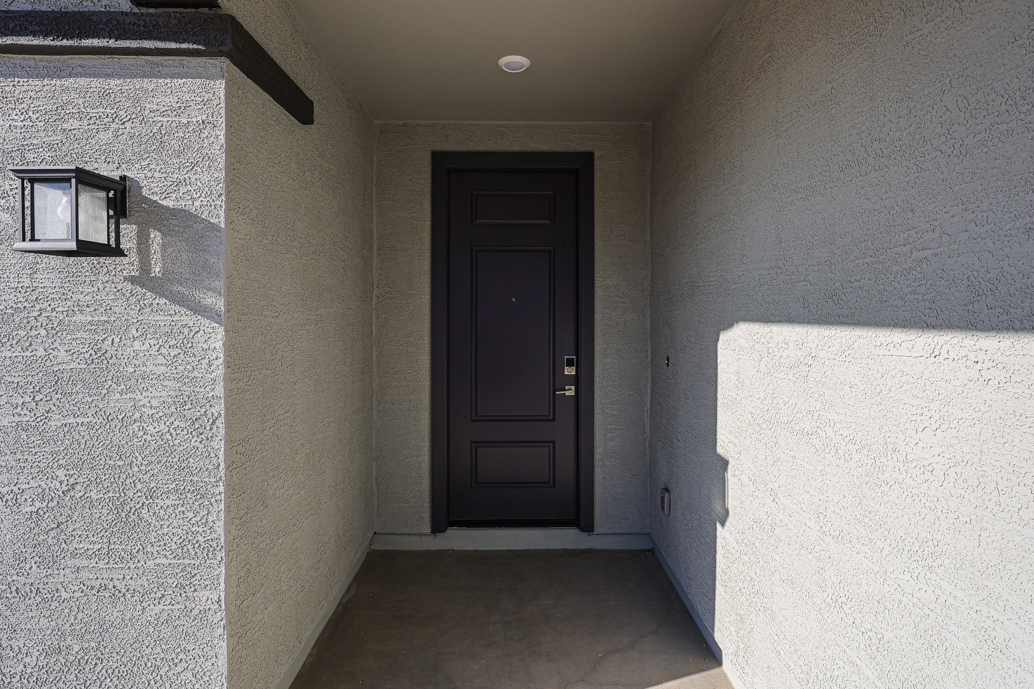 A dark room with a black door.