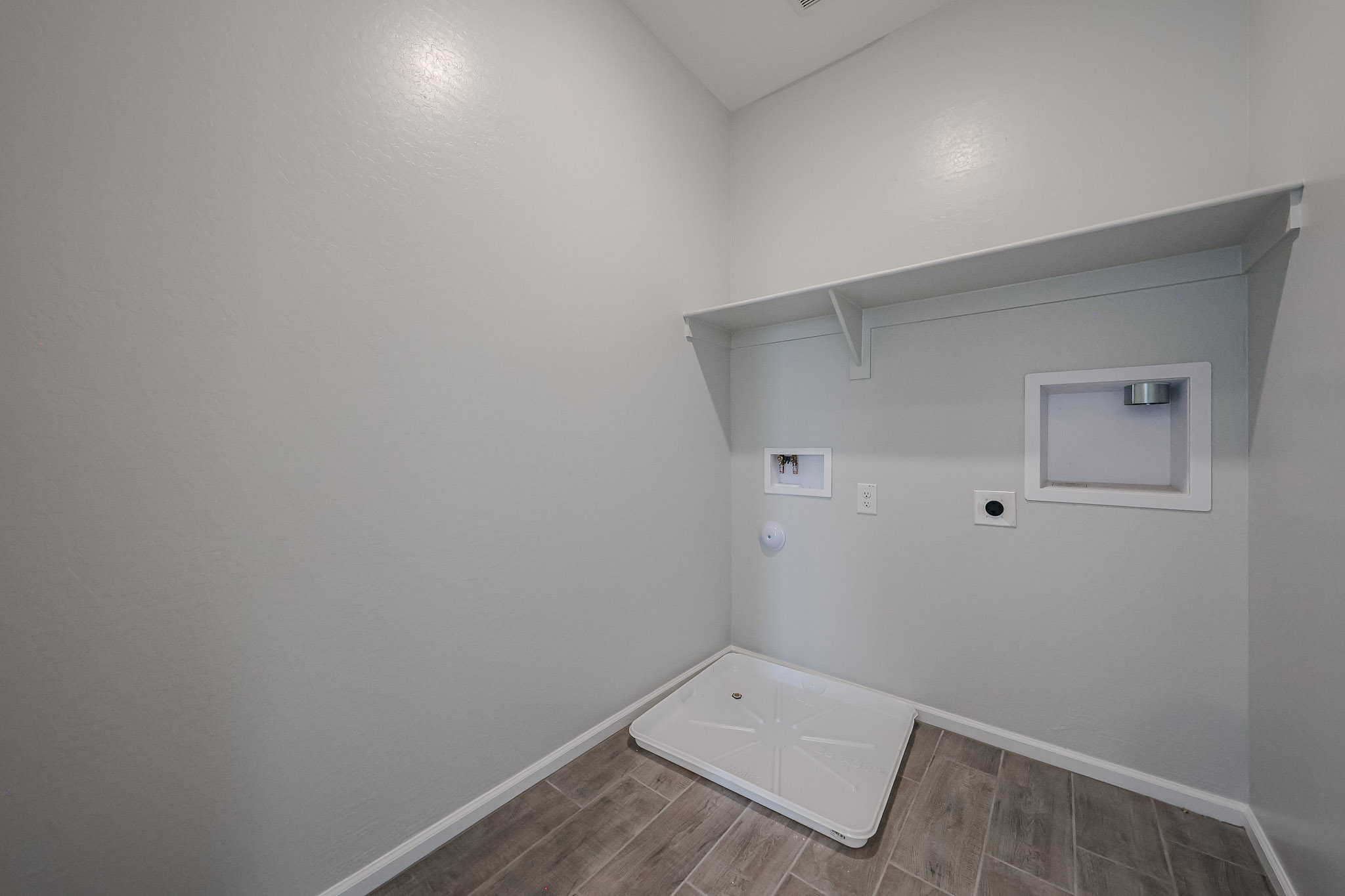 A white room with a tile floor.