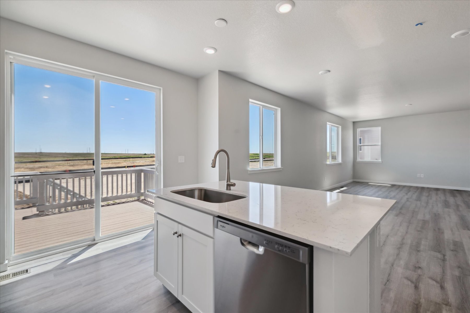 A kitchen with a large window.