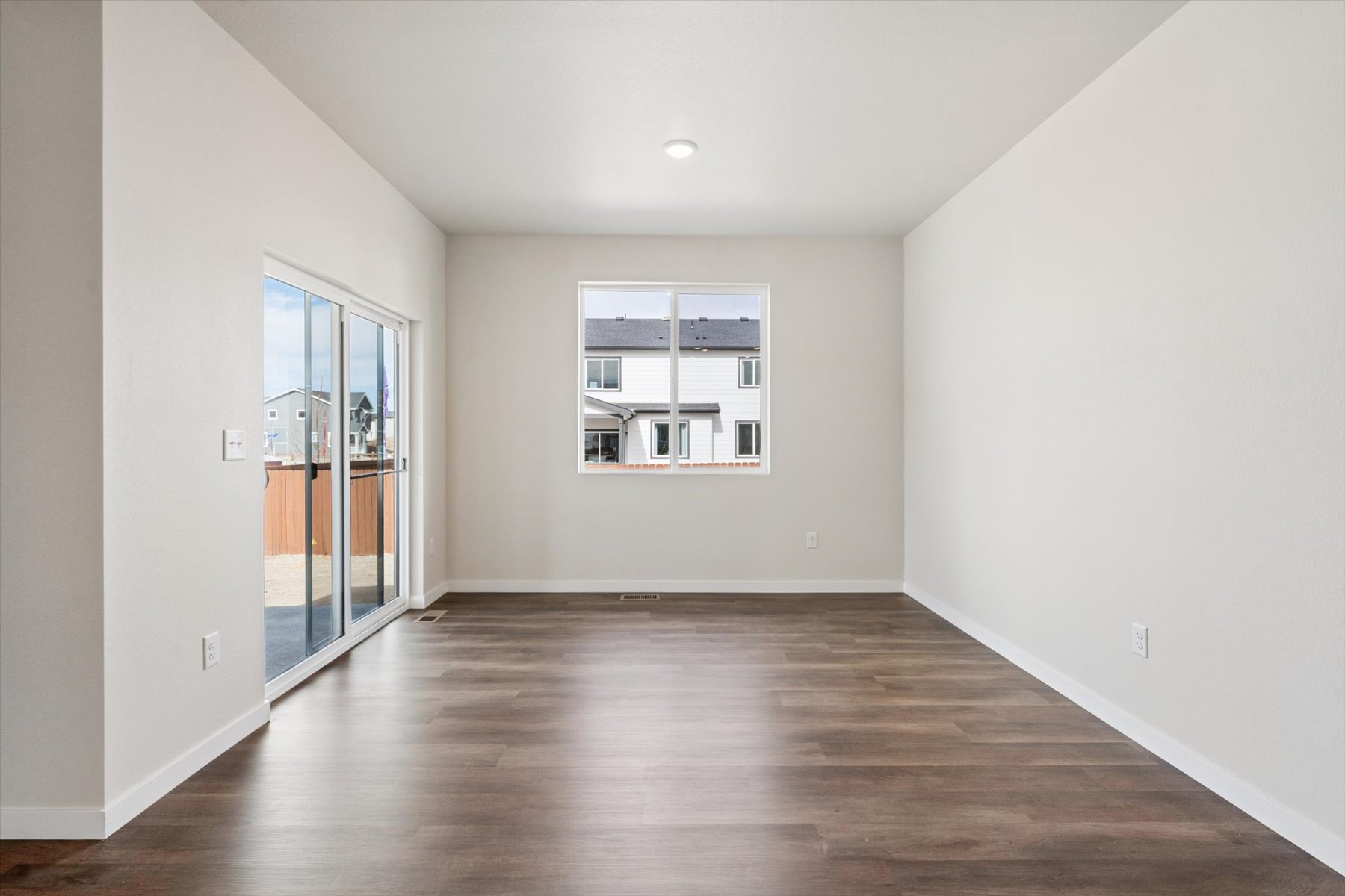A room with a wood floor and a window.
