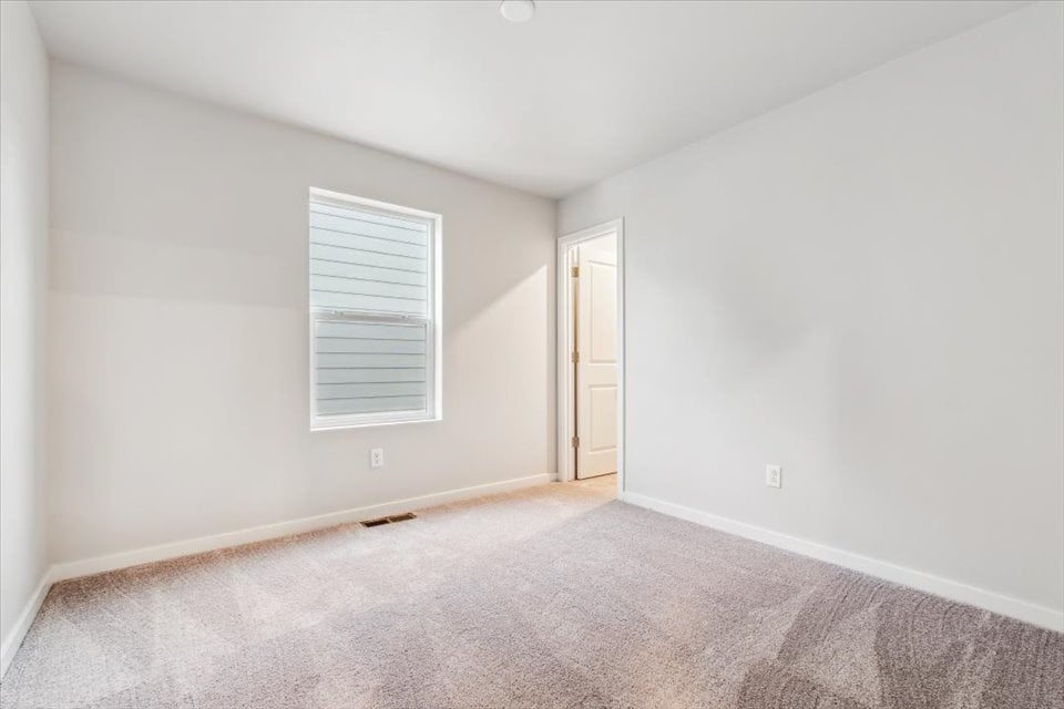 A room with a door and a carpet.