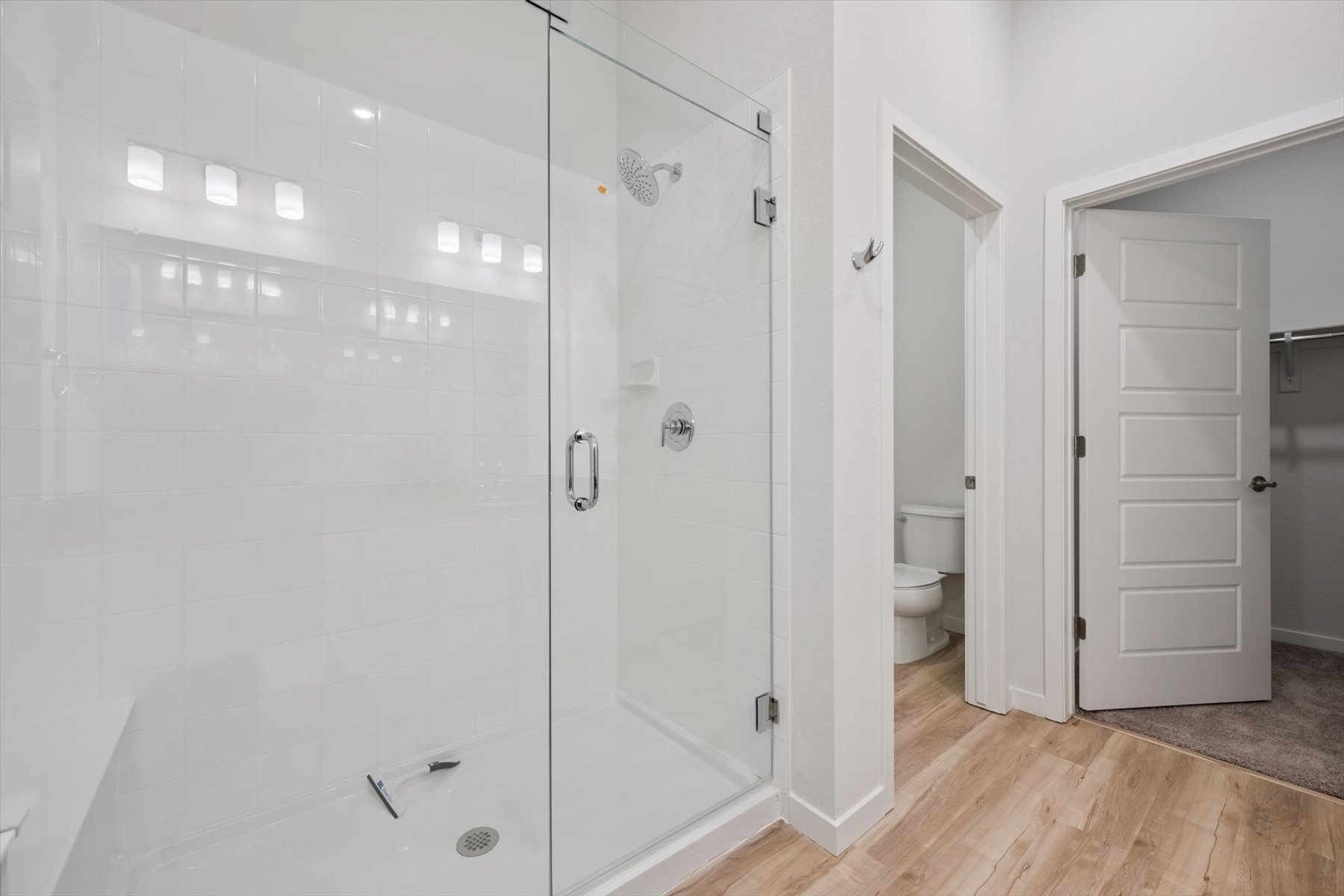 A bathroom with white doors.