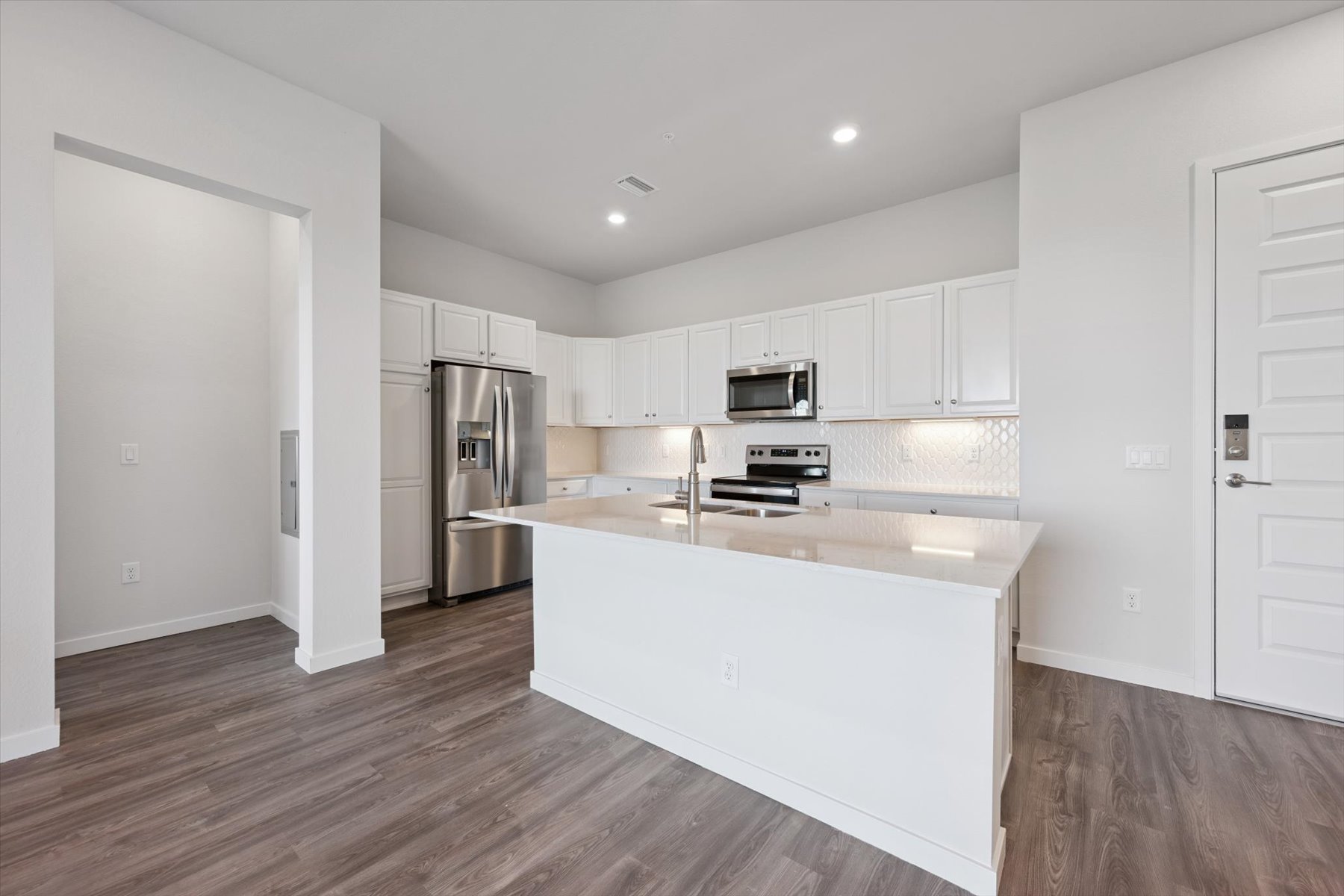 A kitchen with white cabinets.