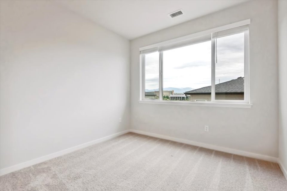 A room with a window and a carpet.