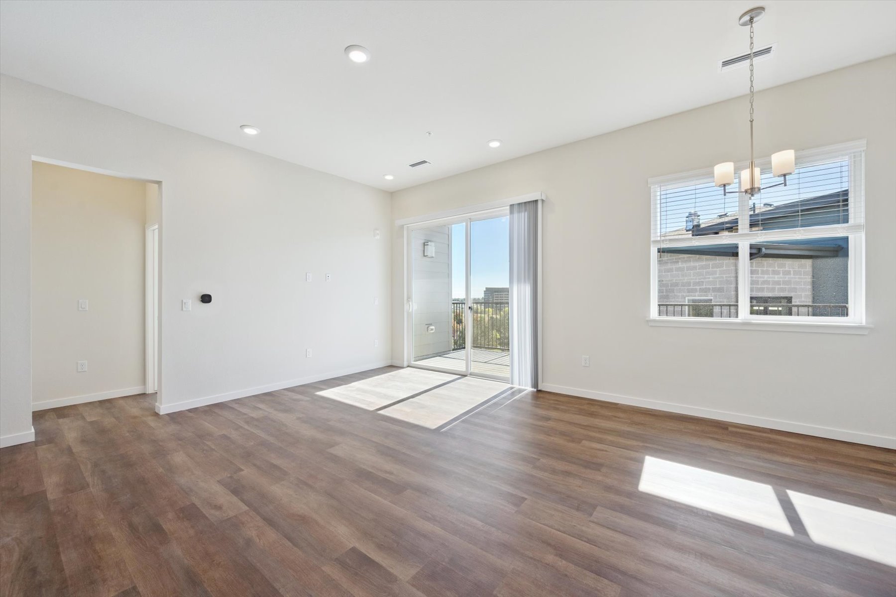 A room with a wood floor and a wood floor with a window.