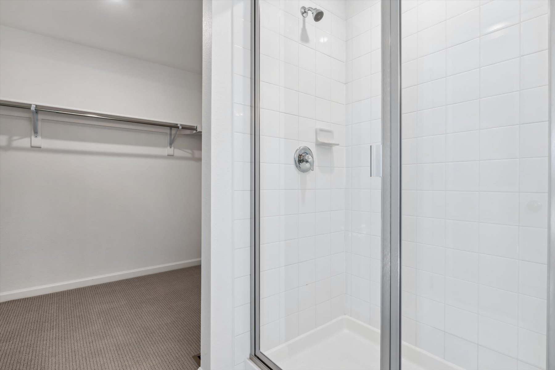 A shower with a glass door.