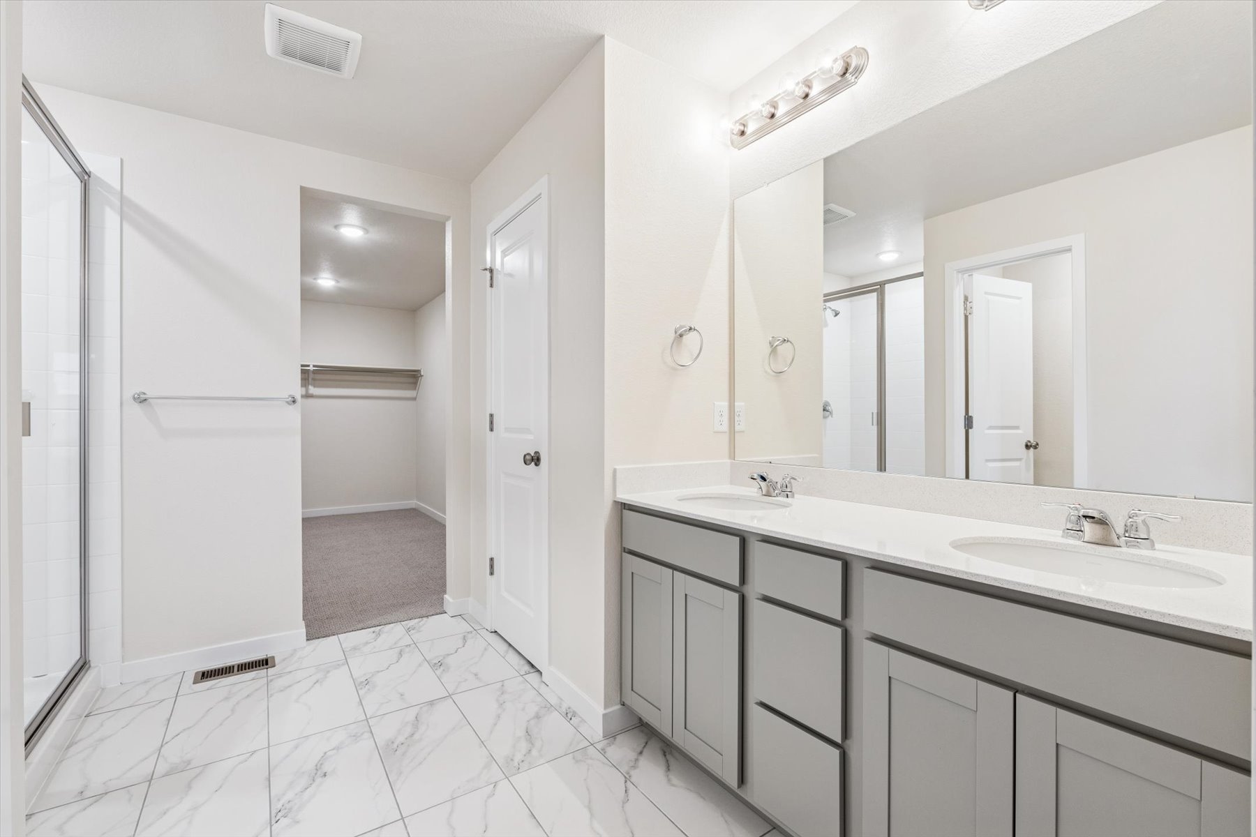 A bathroom with a large mirror.