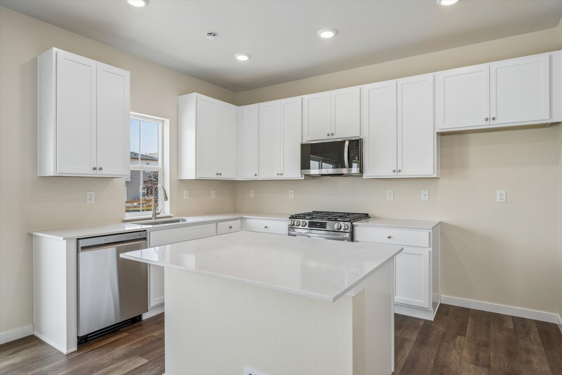 A kitchen with white cabinets.