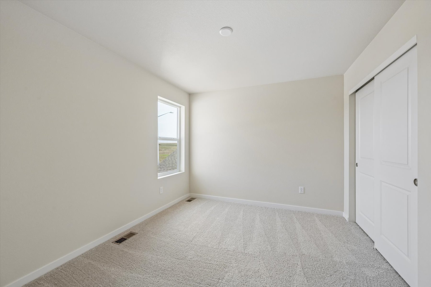 A room with white walls and a carpeted floor.
