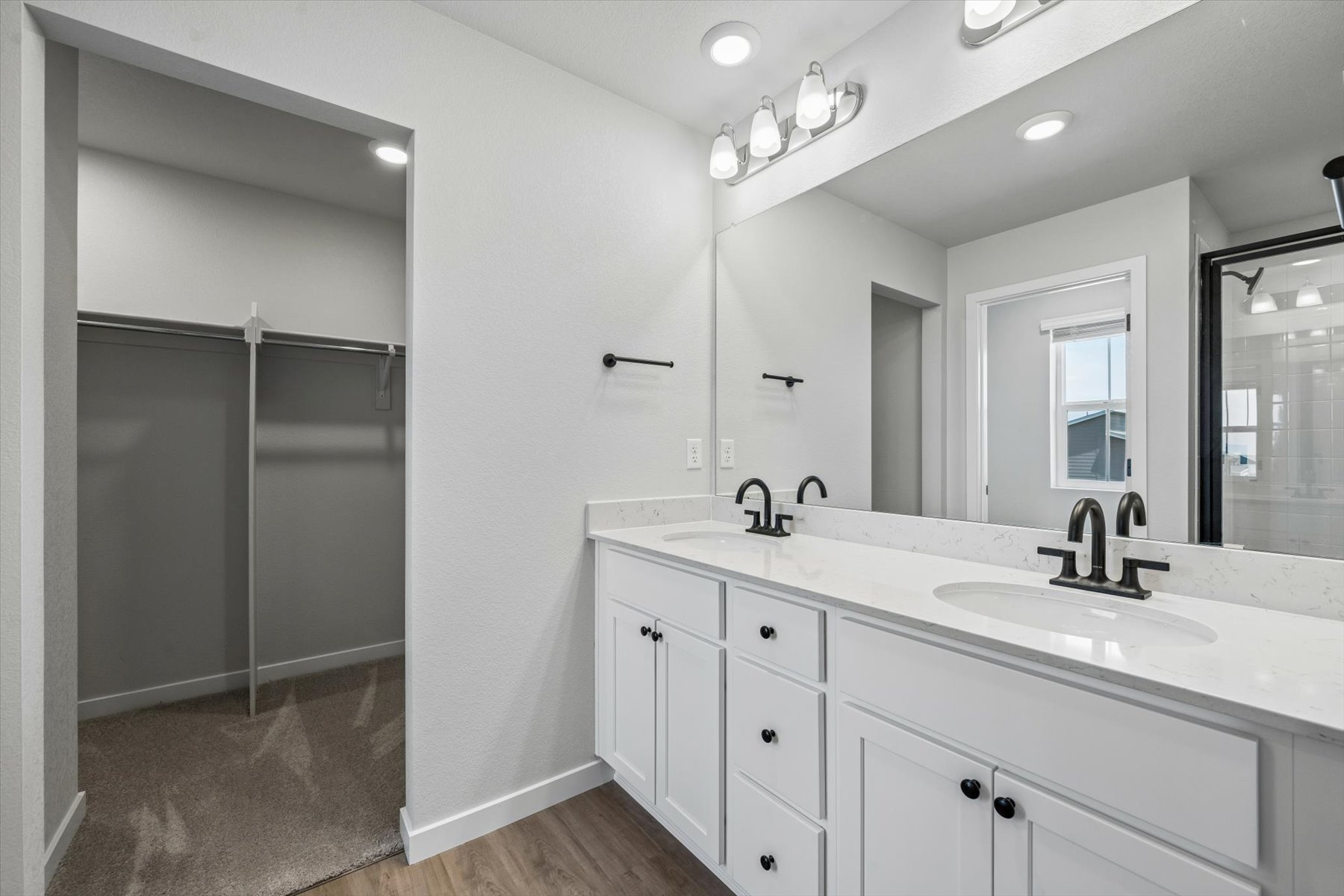 A bathroom with a sink and a shower unit.