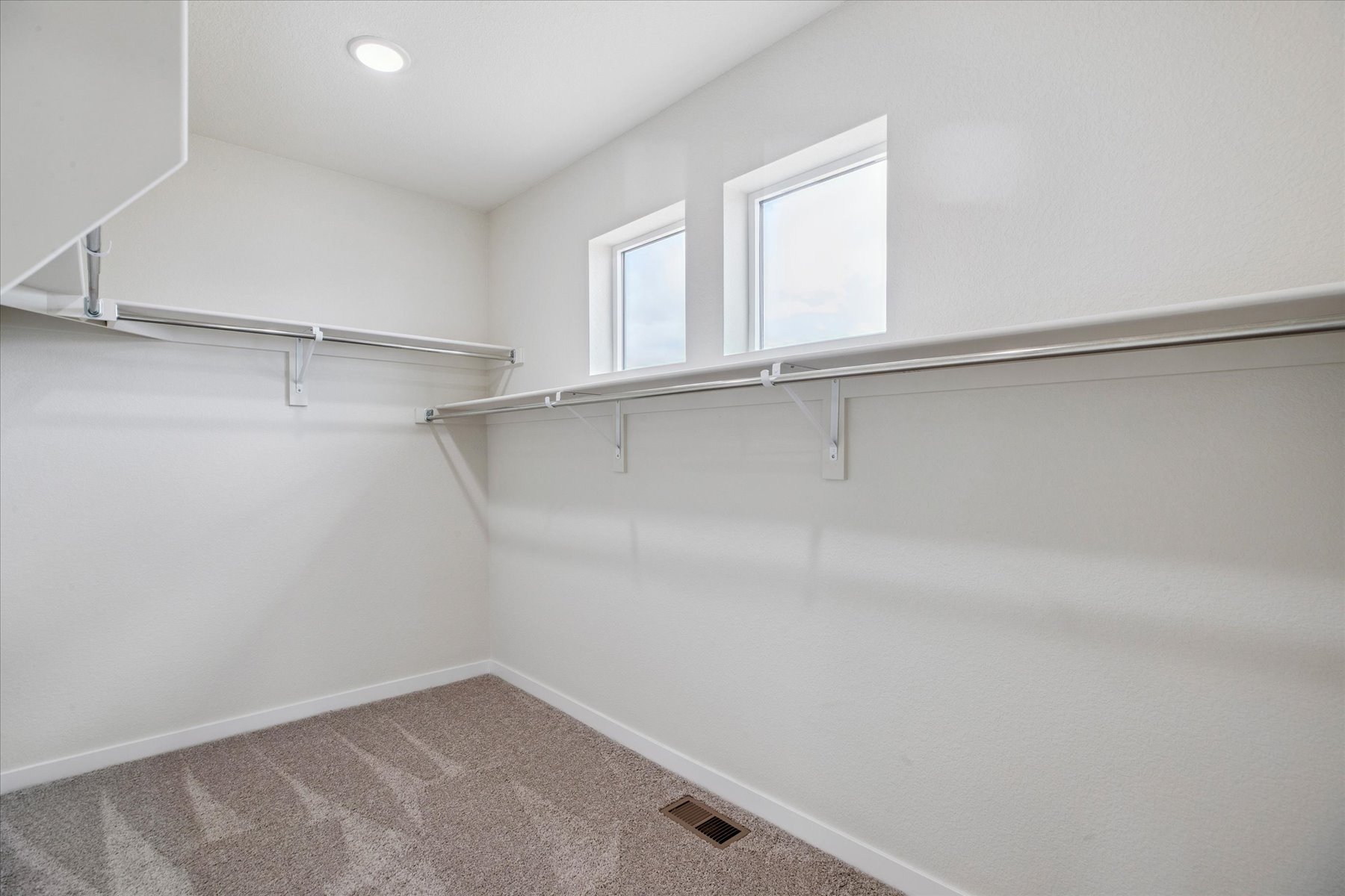 A white room with a metal railing.