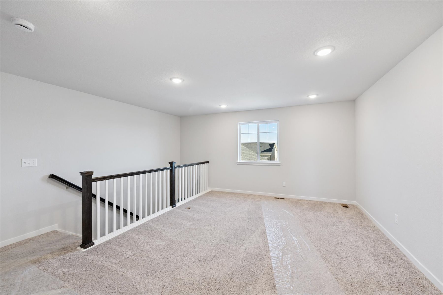 A room with a railing and a window.