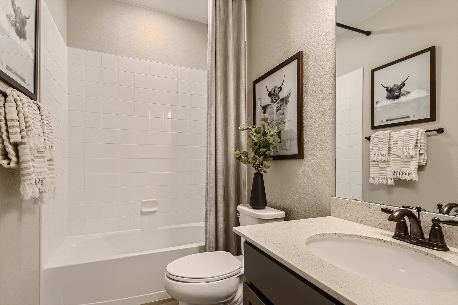 A bathroom with a sink toilet and a bathtub.