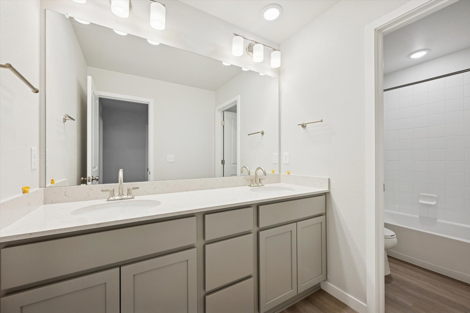 A bathroom with a large mirror.