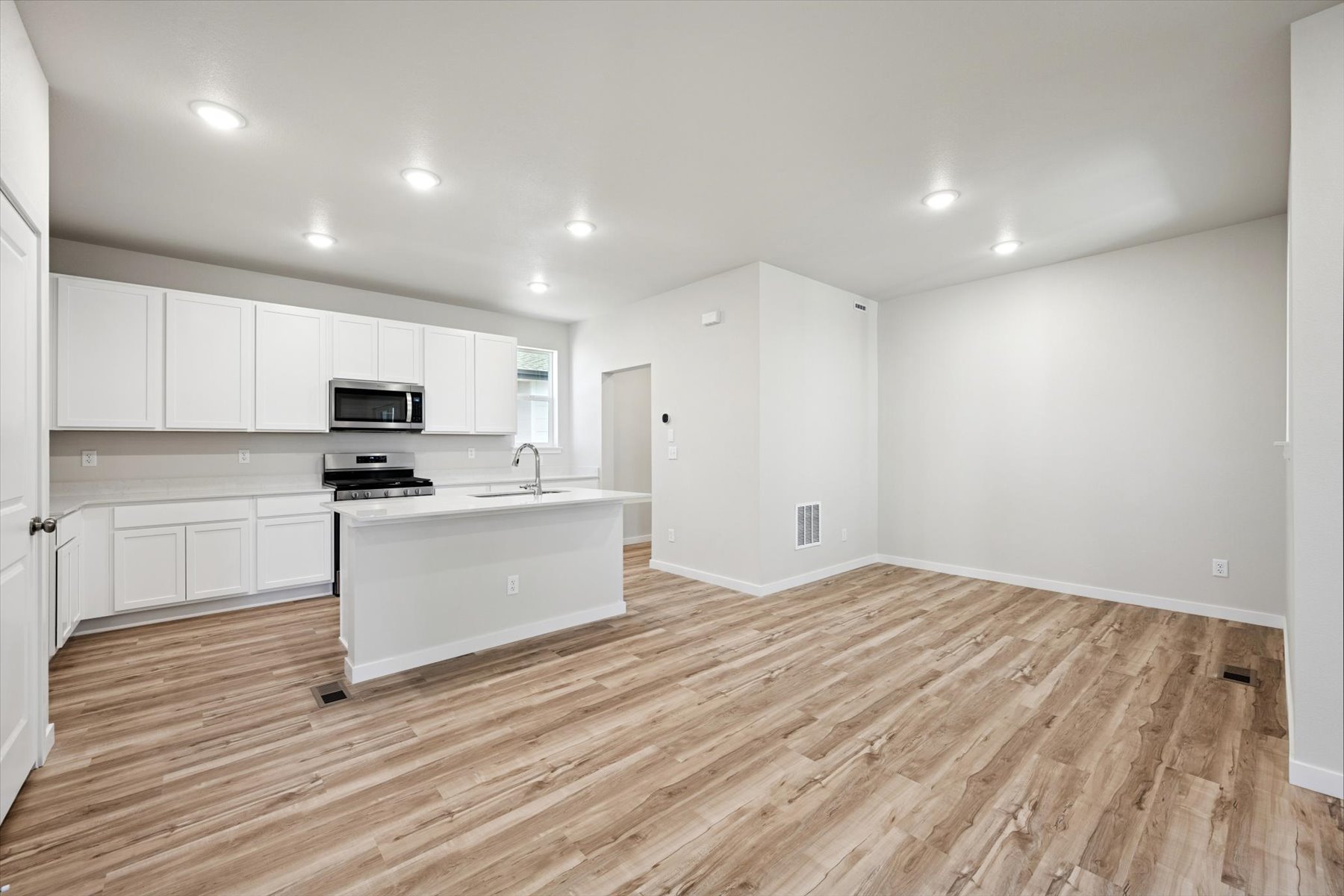 A kitchen with white cabinets.