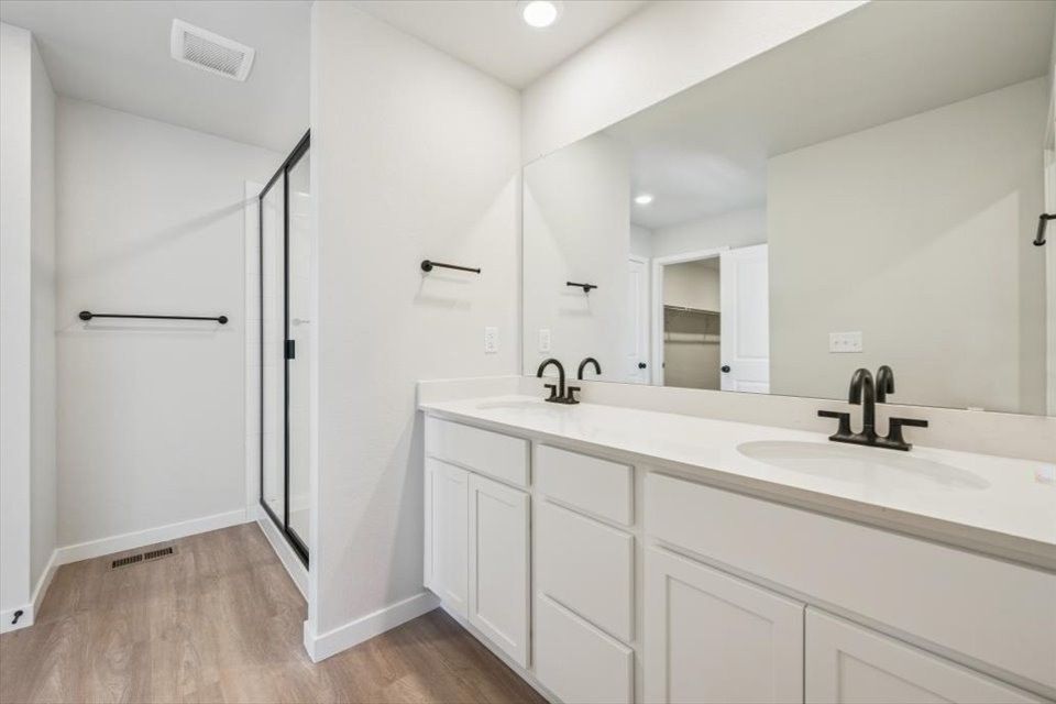 A bathroom with white cabinets.