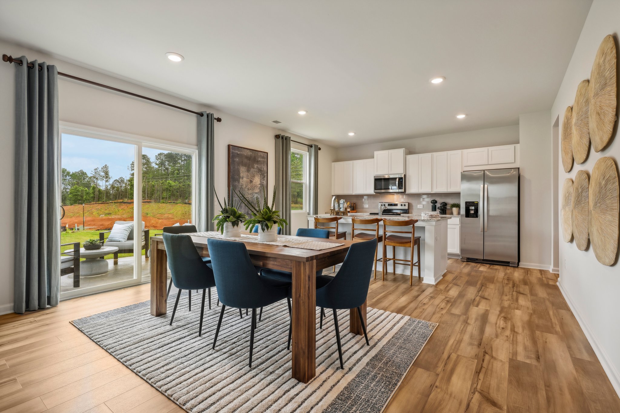 A kitchen with a dining table and chairs.