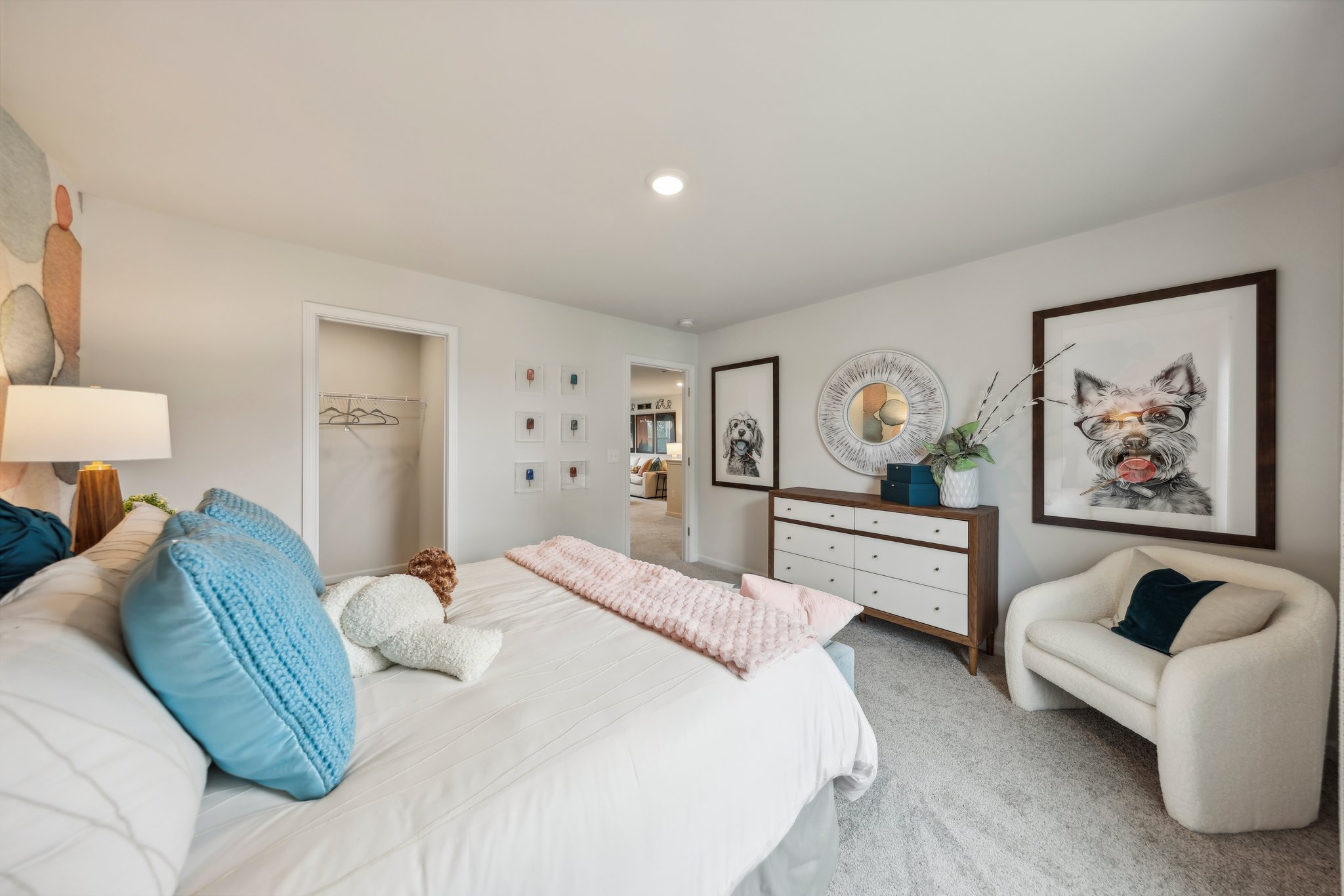 A bedroom with a bed and a chair.