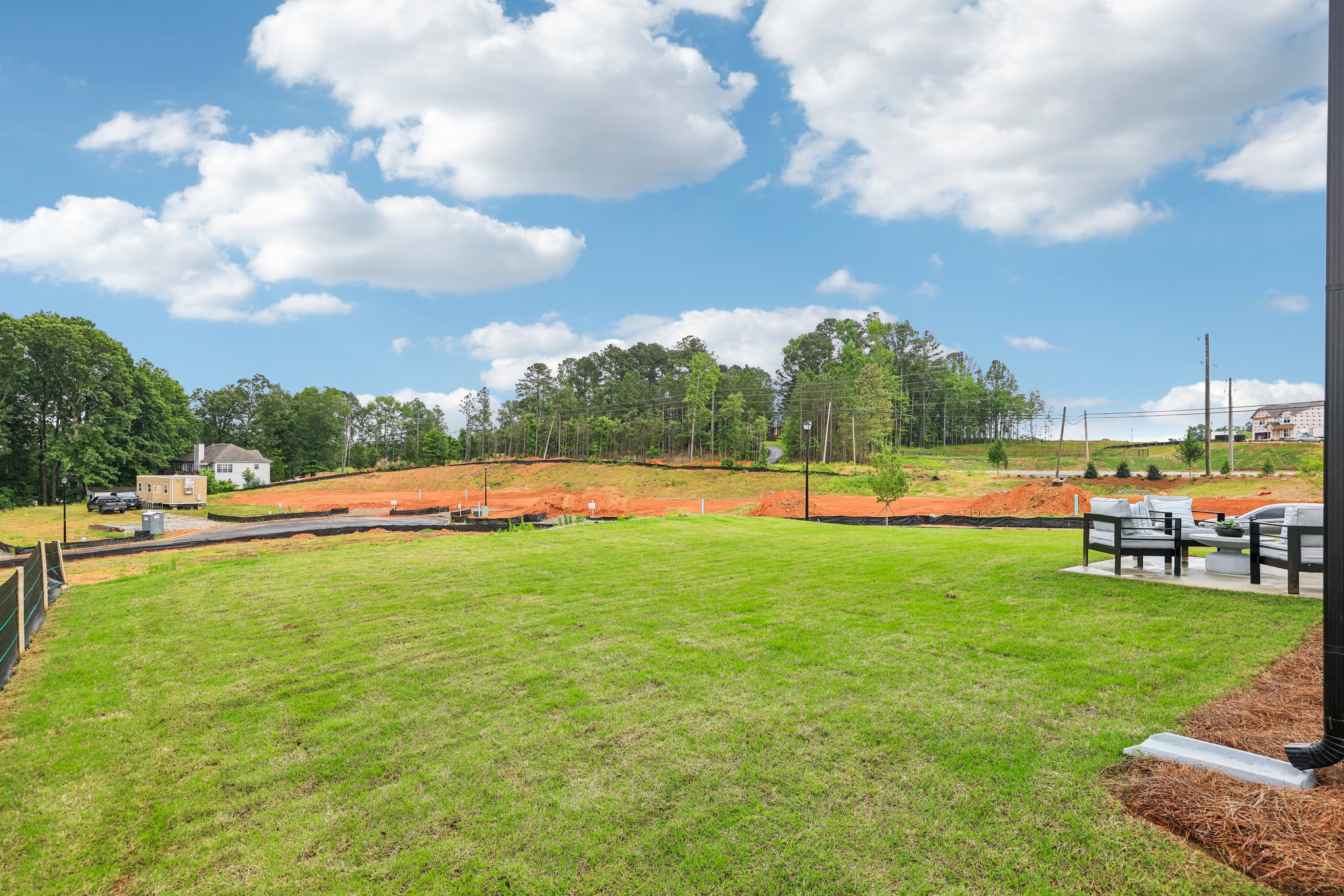 A grassy field with trees in the background.