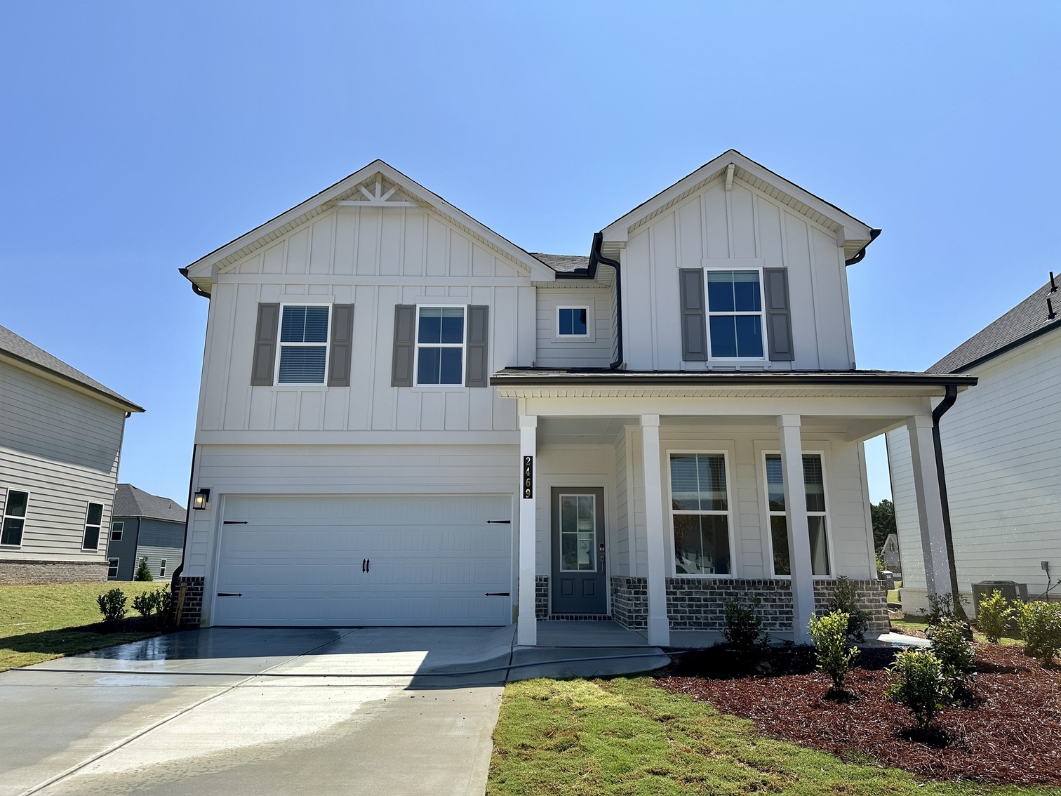 A white house with a driveway.