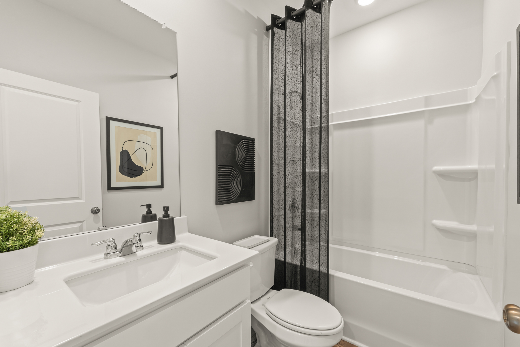 A bathroom with a shower curtain.