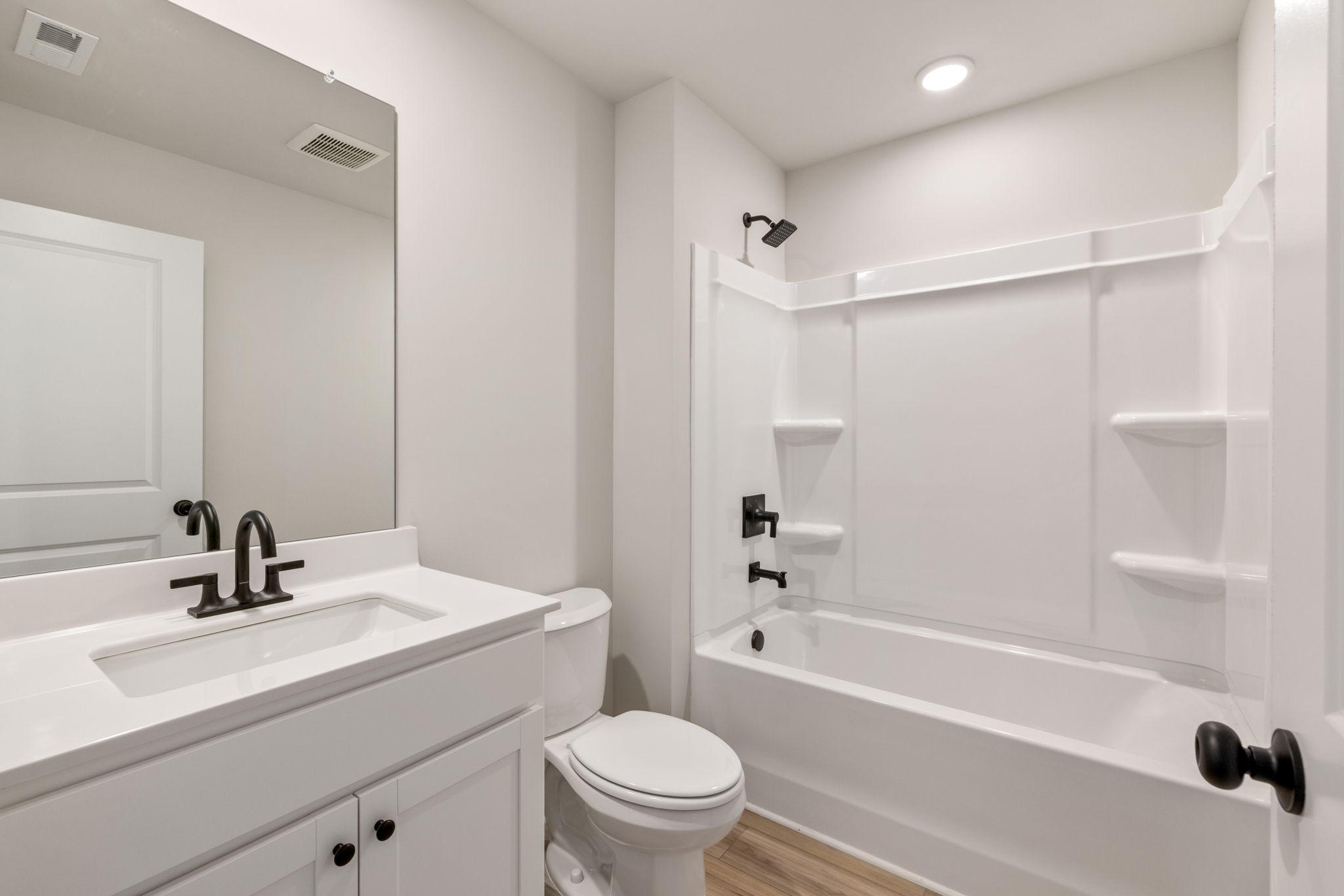 A bathroom with a tub toilet and sink.