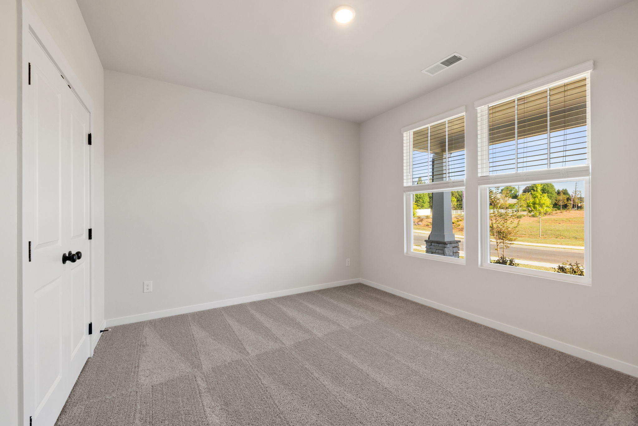 A room with a window and a door.