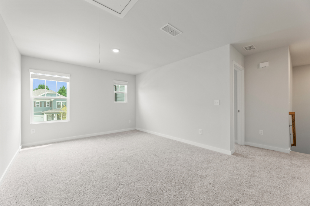 A room with white walls and a window.