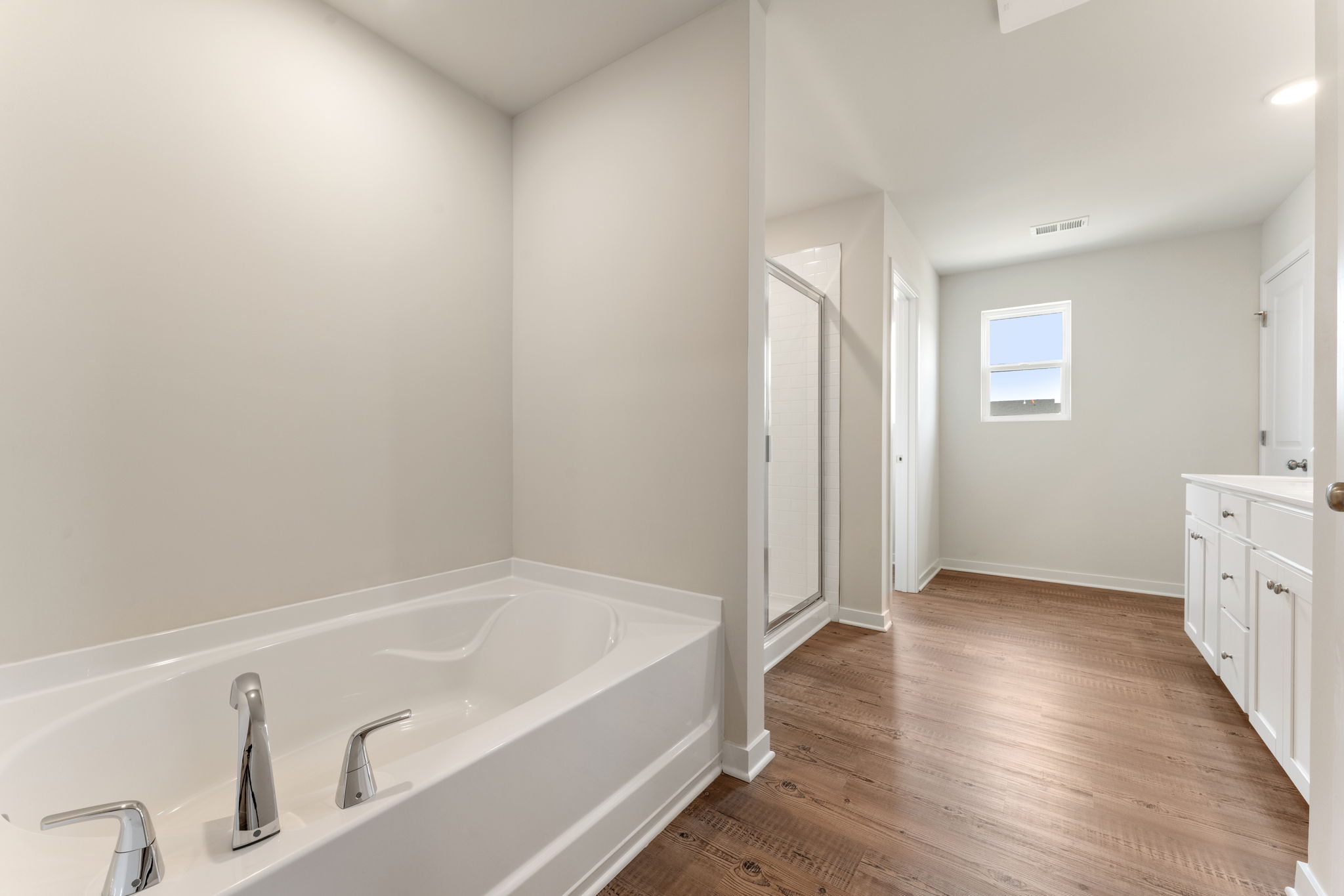 A bathroom with a tub and sink.